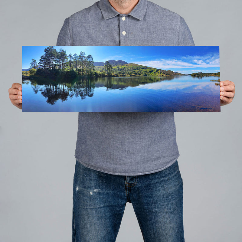 A man holds a 60x20cm panoramic canvas print