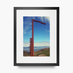 A portrait shaped frame print in a black frame featuring The Sheep's Head stop on the Wild Atlantic Way