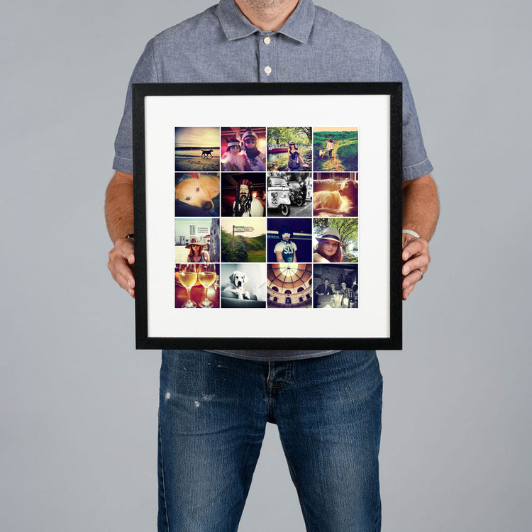 A man holds a black framed custom photo grid collage print against a solid gray background. The print is 30x30cm and the frame is 44x44cm. 